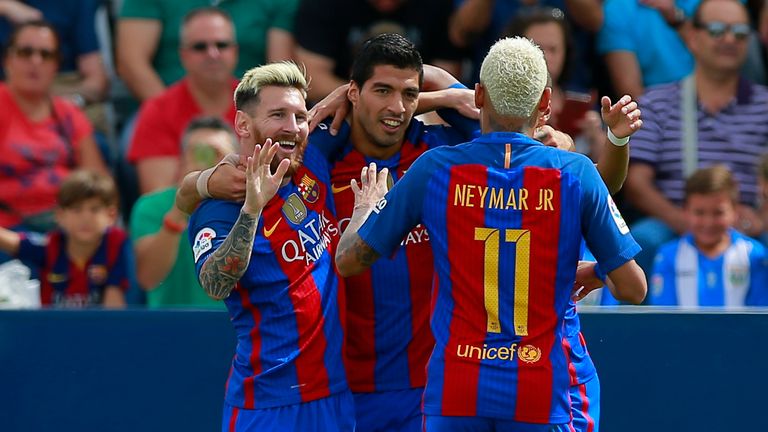 Lionel Messi (L) celebrates scoring their opening goal with teammate Luis Suarez (2ndL) and Neymar