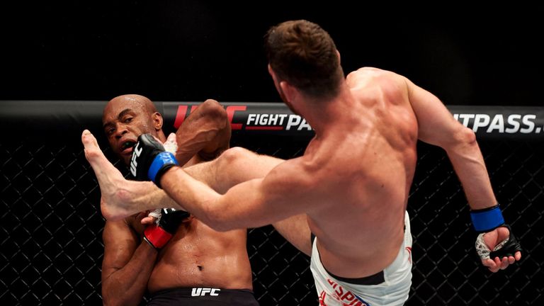 British fighter Michael Bisping (R) kicks out during his fight with Anderson Silva of Brazil (L) in their middleweight bout at the Ultimate Fighting Champi