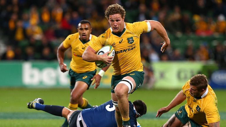 Michael Hooper  breaks from a tackle as he runs in a try