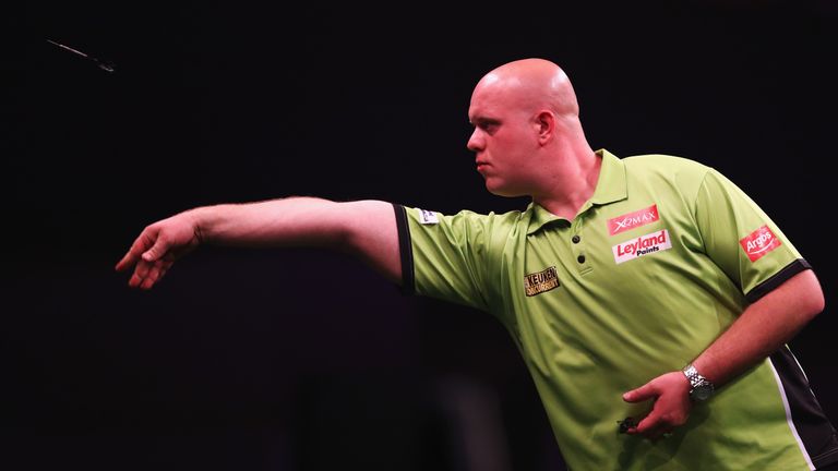 Michael van Gerwen of the Netherlands plays a shot in his match against Phil Taylor