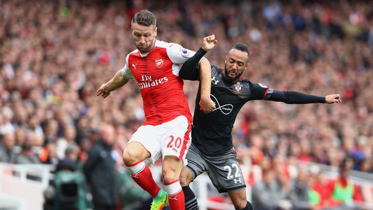 Shkodran Mustafi vies with Southampton's Nathan Redmond at the Emirates