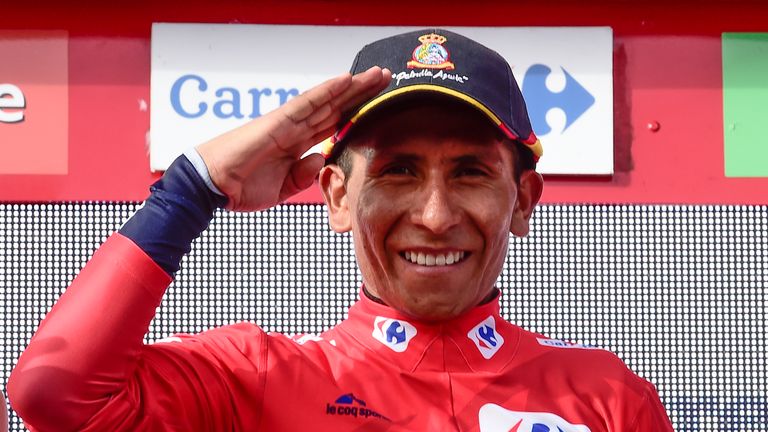 Movistar's Colombian cyclist Nairo Quintana gestures as he celebrates on the podium retaining the red jersey after 20th stage of the 71st edition of "La Vu