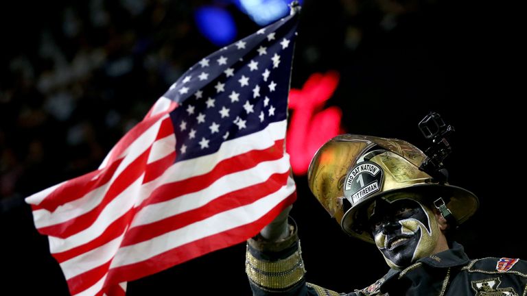 NEW ORLEANS, LA - SEPTEMBER 11:  A fan waves an American flag during a game between the Oakland Raiders and the New Orleans Saints at the Mercedes-Benz Sup