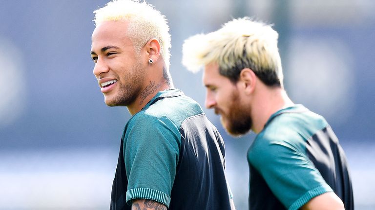 Neymar Jr. (L) and Lionel Messi during a training session ahead of their UEFA Champions League Group C match against Celtic