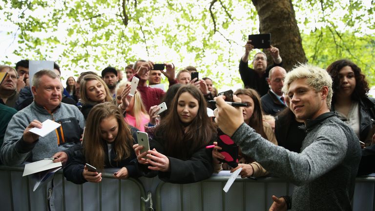 VIRGINIA WATER, ENGLAND - MAY 25:  Niall Horan of One Direction takes a selfie with fans after the Pro-Am prior to the BMW PGA Championship at Wentworth on