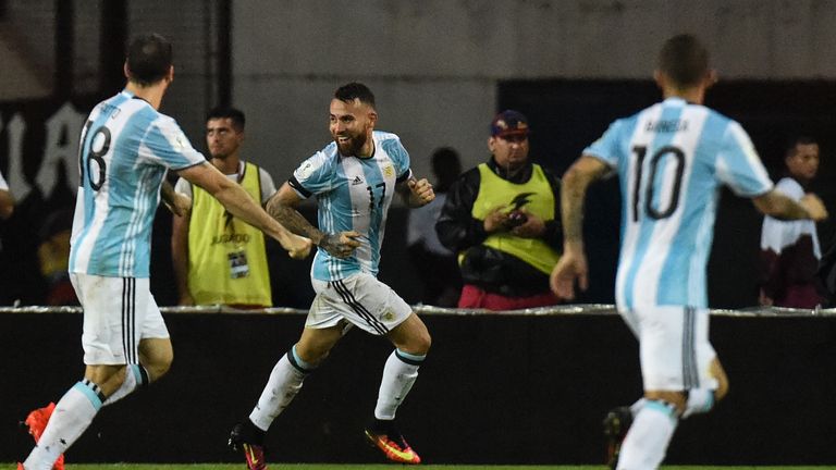 Argentina's Nicolas Otamendi (C) celebrates after scoring against Venezuela 
