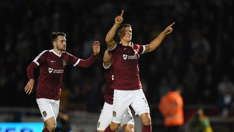 Alex Revell of Northampton Town celebrates after scoring from the penalty spot against Man United