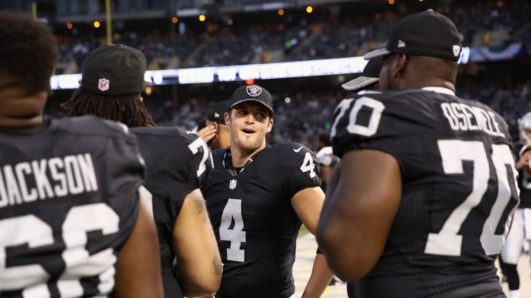 OAKLAND, CA - SEPTEMBER 01:  Derek Carr #4 of the Oakland Raiders talks to his teammates on the sidelines during their preseason game against the Seattle S