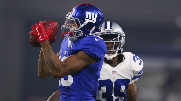 ARLINGTON, TX - SEPTEMBER 13:   Odell Beckham #13 of the New York Giants makes a catch against  Brandon Carr #39 of the Dallas Cowboys in the fourth quarte