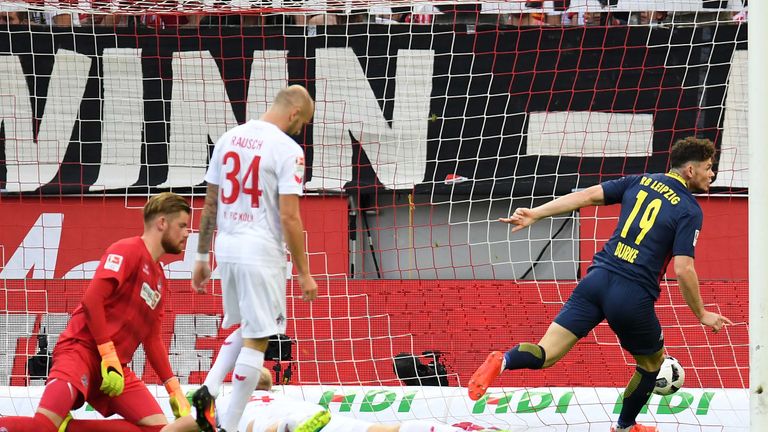 Leipzig's Scottish midfielder Oliver Burke (R) scores the opening goal past Cologne's goalkeeper Timo Horn (L) during the German first division Bundesliga 