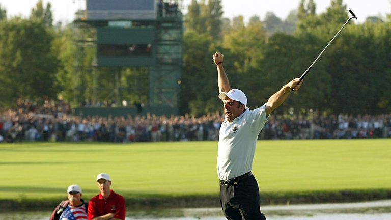 SUTTON COLDFIELD, UNITED KINGDOM:  Paul McGinley (R) of Ireland leaps in the air after sinking the winning putt on the 18th green to win the 34th Ryder Cup