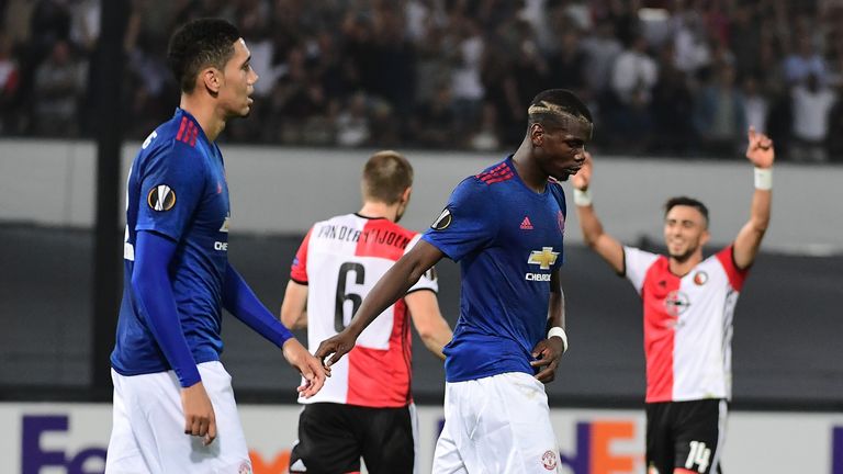 Manchester United's Paul Pogba (C) and Manchester United's English defender Chris Smalling react after losing the UEFA Europa League football match between