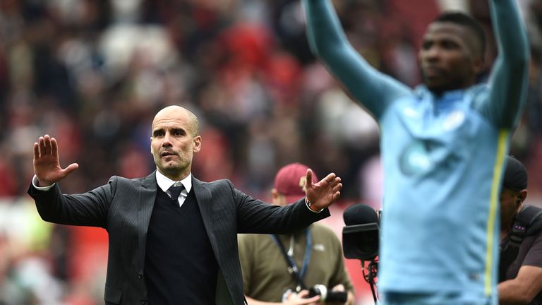 Pep Guardiola and his players celebrate a 2-1 victory at full-time in the Manchester derby