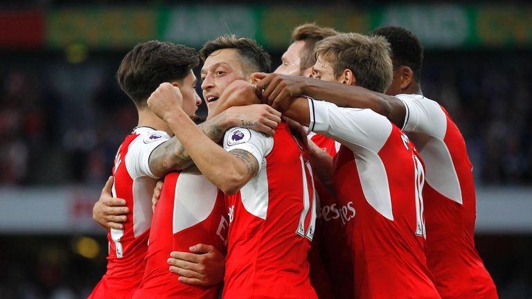 Arsenal's Mesut Ozil (C) celebrates scoring their third goal