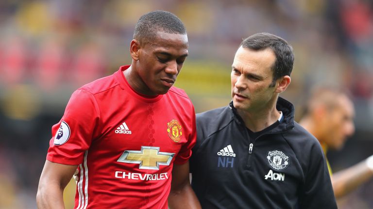 Anthony Martial is taken off the pitch by a member of the medial team