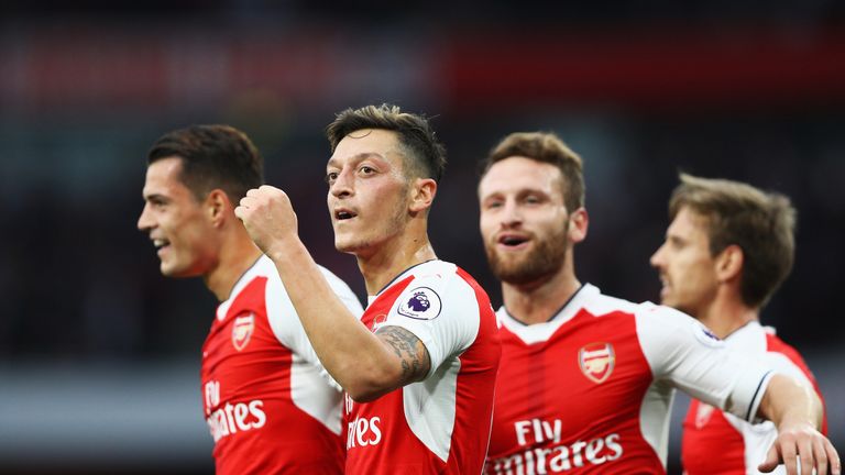 Mesut Ozil (C) celebrates scoring Arsenal's third with his team-mates