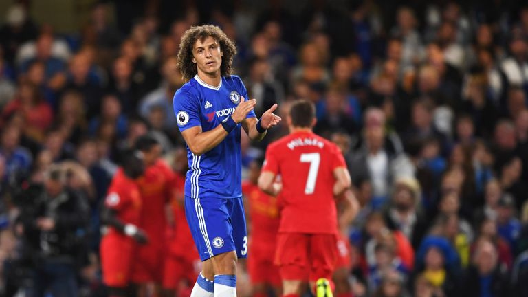 David Luiz reacts as Liverpool players celebrate Dejan Lovren's goal