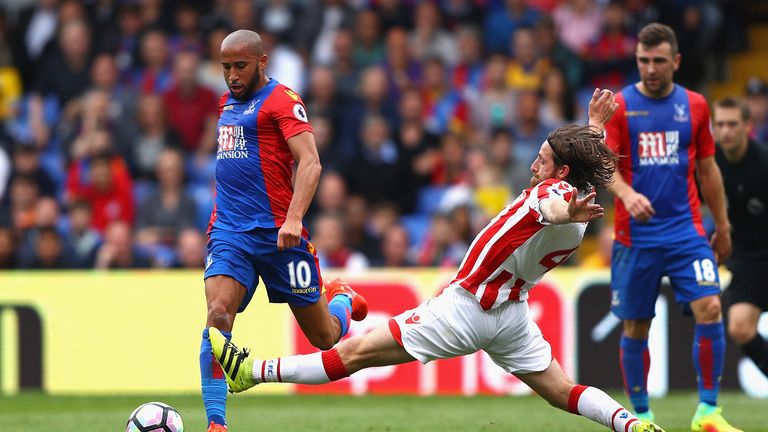 Andros Townsend (L) takes on Joe Allen at Selhurst Park