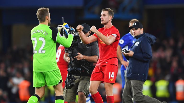 Match winner Jordan Henderson (R) celebrates victory with Simon Mignolet