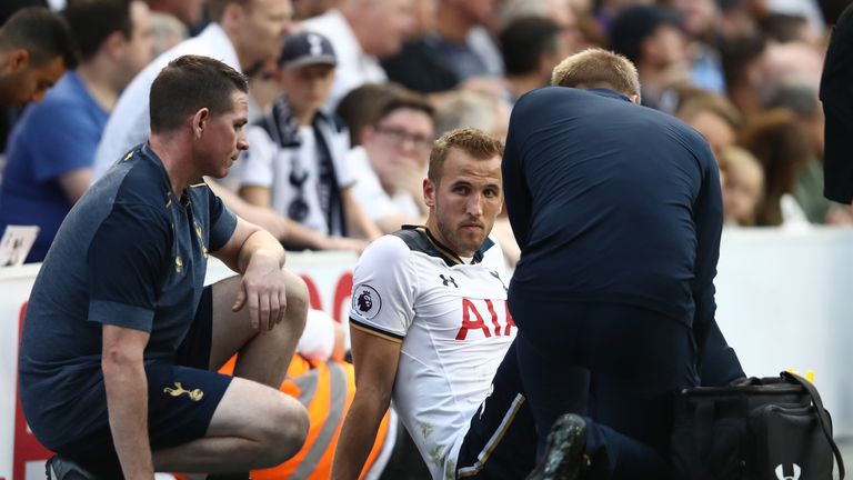 Harry Kane receives treatment from the Tottenham medical team