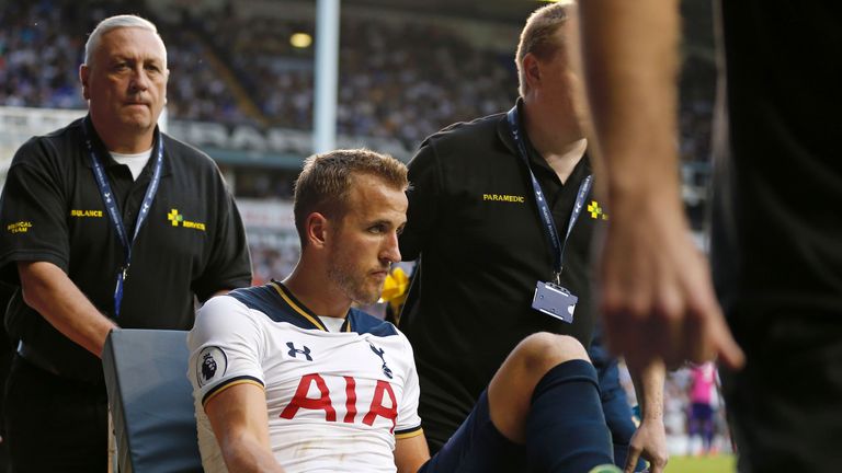 Harry Kane exits the game the on a stretcher after leaving the pitch injured