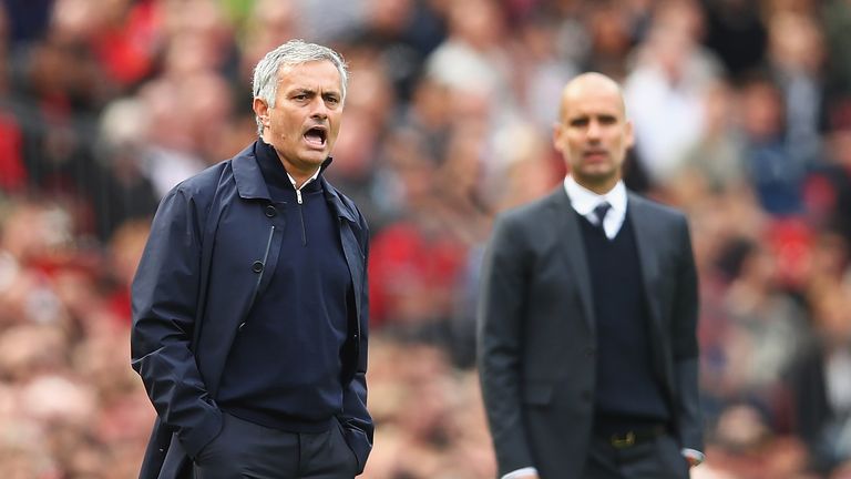 Jose Mourinho (L) shouts towards his players at Old Trafford