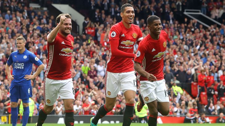 Marcus Rashford (R) celebrates scoring Manchester United's third with Juan Mata (L) and Chris Smalling