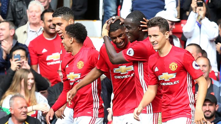 Marcus Rashford celebrates with his team-mates after scoring for Manchester United