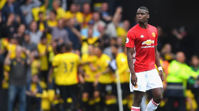 Paul Pogba looks on as Watford players celebrate at Vicarage Road
