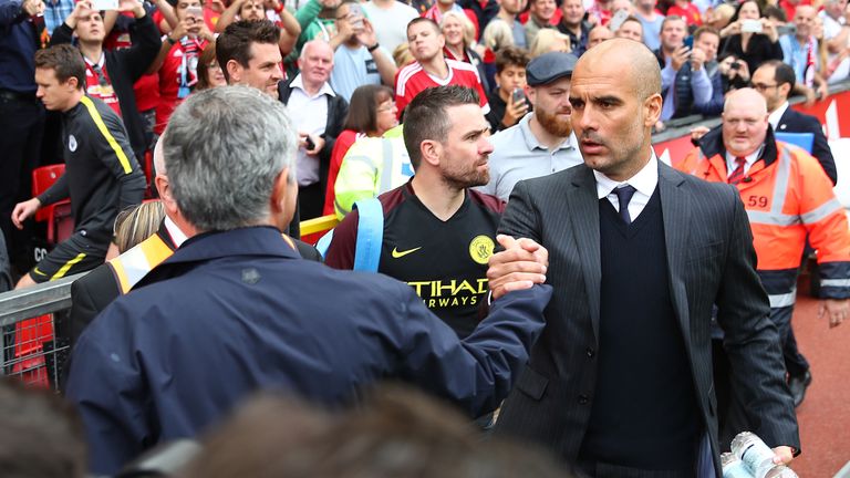 Jose Mourinho (L) shakes hands with Pep Guardiola prior to kick-off