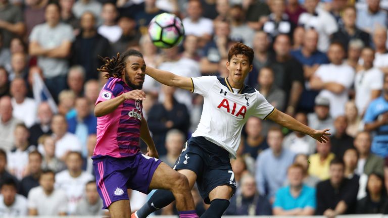 Heung-Min Son of Tottenham Hotspur (R) shoots while Jason Denayer attempts a block