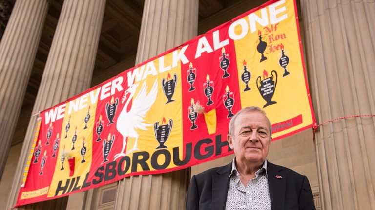 LIVERPOOL, ENGLAND - SEPTEMBER 22: Professor Phil Scraton stands outside St Geroge's Hall as a banner commemorating the Hillsborough disaster hands behind 