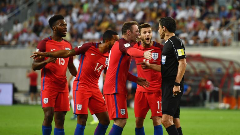 England players appeal to referee Milorad Mazic as Theo Walcott's goal is disallowed 
