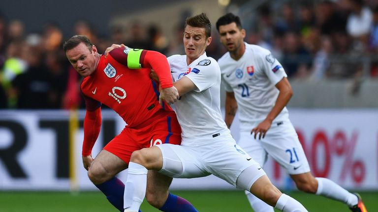  Wayne Rooney  battles with Jan Gregus of Slovakia 