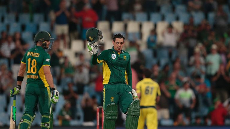 South African batsman Quinton De Kock raises his helmet as he celebrates scoring a century (100 runs) during the ODI cricket match Australia against South 
