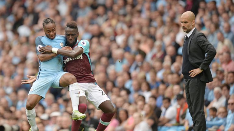 TOPSHOT - West Ham United's French defender Arthur Masuaku vies with Manchester City's English midfielder Raheem Sterling (L) as Manchester City's Spanish 