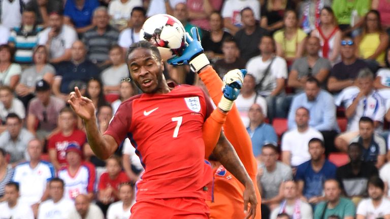 England's midfielder Raheem Sterling (L) vies with Slovakia's goalkeeper Matus Kozacik