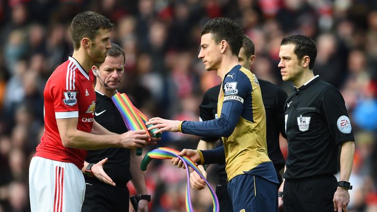 Michael Carrick of Manchester United and Laurent Koscielny of Arsenal exchange rainbow laces before the Premier League match on 28 February 2016
