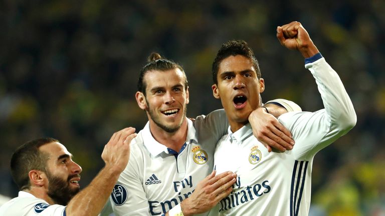 Real Madrid defender Raphael Varane celebrates with Gareth Bale