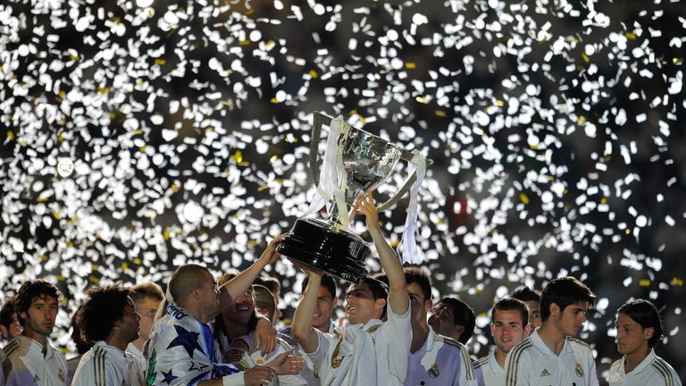 MADRID, SPAIN - MAY 13:  Cristiano Ronaldo of Real Madrid CF holds up the La Liga trophy as he celebrates winning the La Liga title with team-mates after t