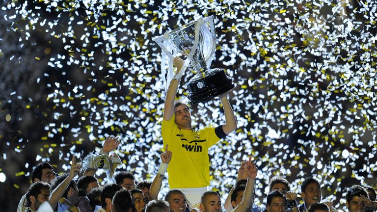 MADRID, SPAIN - MAY 13:  Iker Casillas of Real Madrid CF holds up the La Liga trophy as he celebrates with team-mates after the La Liga match between Real 
