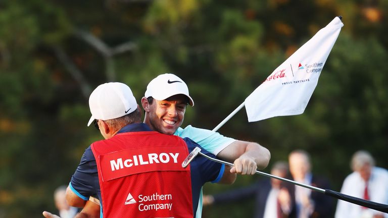 ATLANTA, GA - SEPTEMBER 25:  Rory McIlroy of Northern Ireland celebrates with his caddie J.P. Fitzgerald after holing a birdie putt to defeat Ryan Moore on