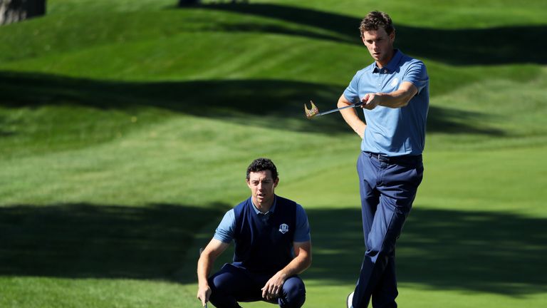 CHASKA, MN - SEPTEMBER 30:  Rory McIlroy and Thomas Pieters of Europe line up a putt on the first green during afternoon fourball matches of the 2016 Ryder