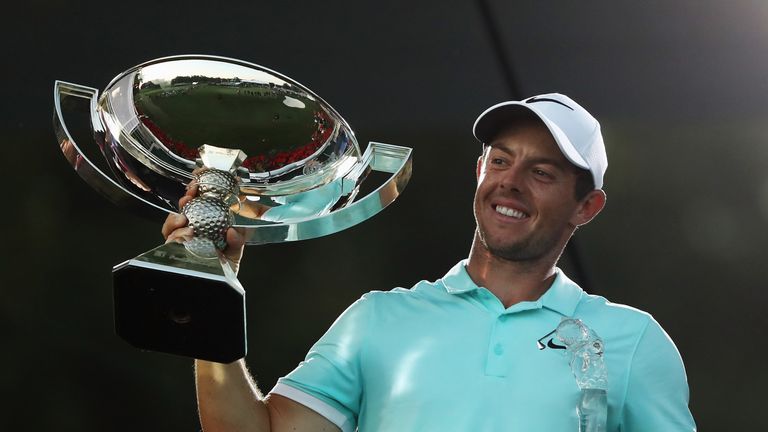 Rory McIlroy of Northern Ireland poses with the FedExCup and Tour Championship trophies 