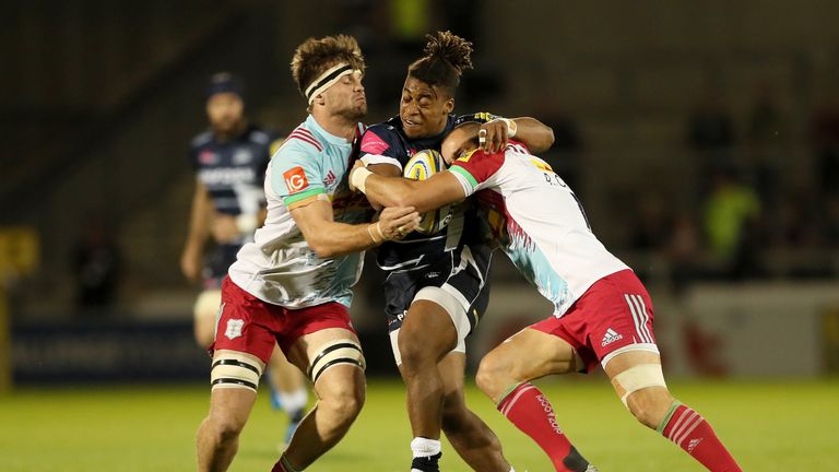 Paolo Odogwu is tackled by Jack Clifford (left) and Ross Chisholm