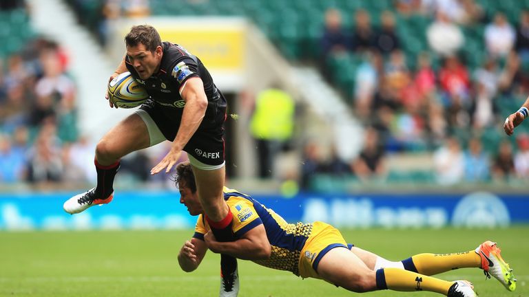  Alex Goode is tackled by Worcester's Dean Hammond