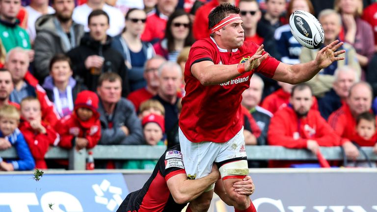 CJ Stander makes a pass despite the efforts of Edinburgh's Hamish Watson