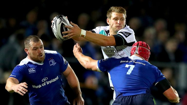 Leinster's Cian Healy and Josh van der Flier tackle Dan Biggar