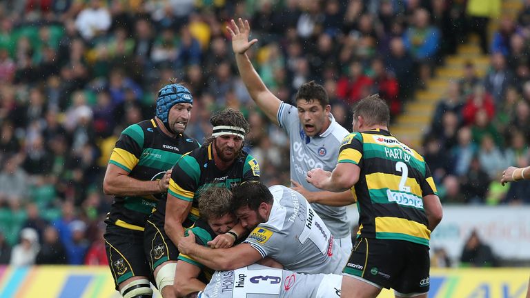 Jamie Gibson is tackled by Bath props Nathan Catt and Henry Thomas