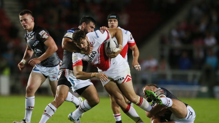 Alex Walmsley is tackled by Castleford's Paul McShane (left) and Matt Cook  